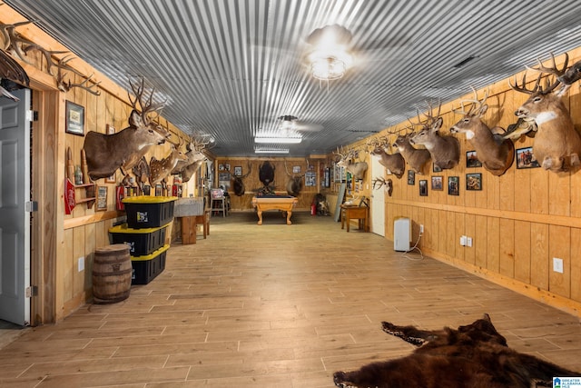 miscellaneous room featuring wooden walls, billiards, and light wood-type flooring