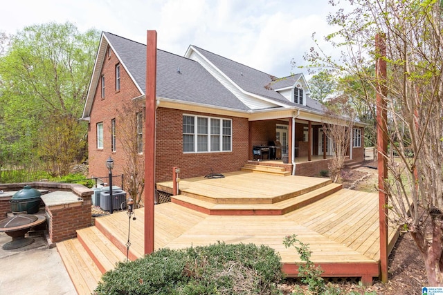 back of property featuring a deck and central air condition unit