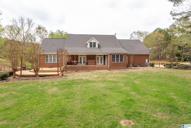 rear view of house with a wooden deck and a yard