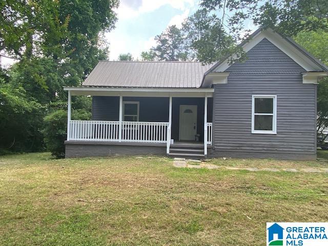 view of front of house featuring a front yard and covered porch