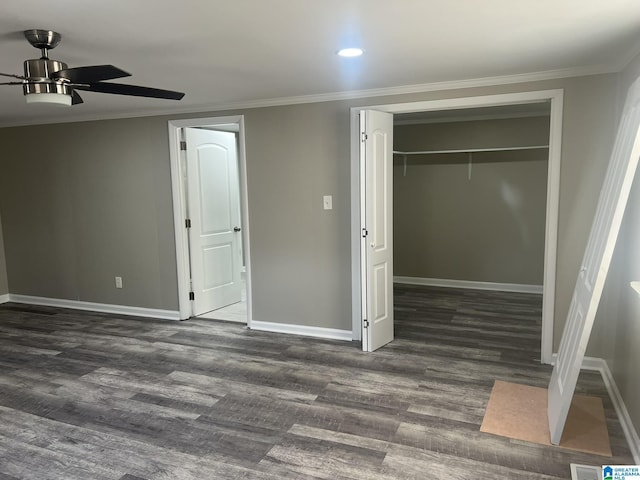 unfurnished bedroom featuring dark wood-style floors, baseboards, and crown molding