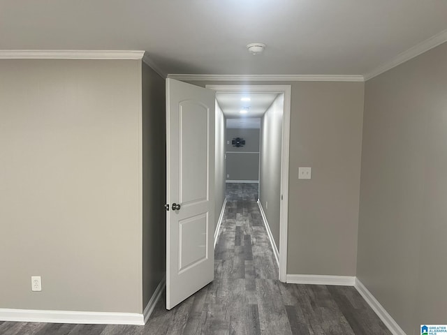 hall featuring ornamental molding, dark wood finished floors, and baseboards