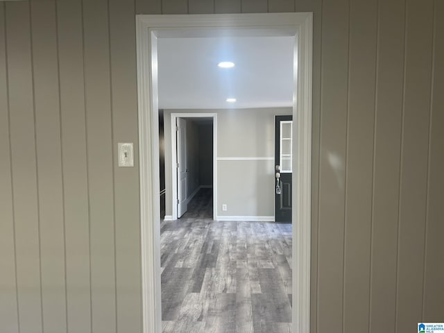 corridor featuring wood finished floors and baseboards