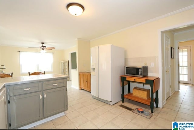 kitchen with white appliances, light tile patterned floors, ceiling fan, tile countertops, and gray cabinetry