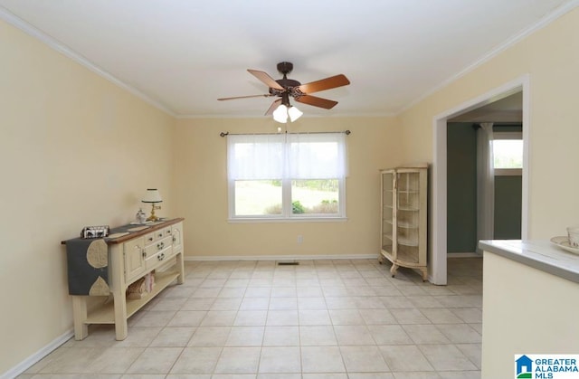 empty room featuring light tile patterned flooring, crown molding, ceiling fan, and a healthy amount of sunlight