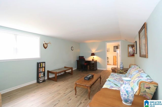 living room with vaulted ceiling and light hardwood / wood-style floors