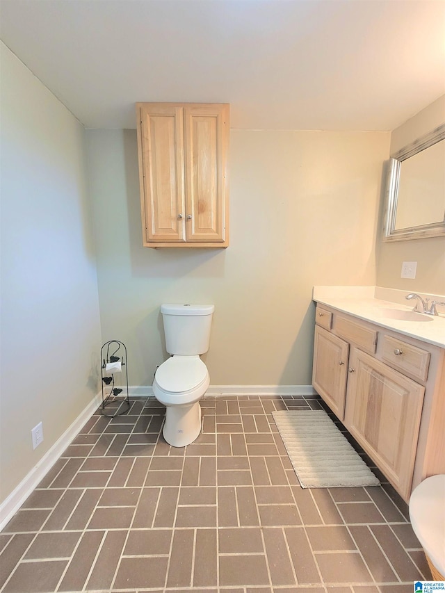 bathroom with vanity, tile patterned flooring, and toilet