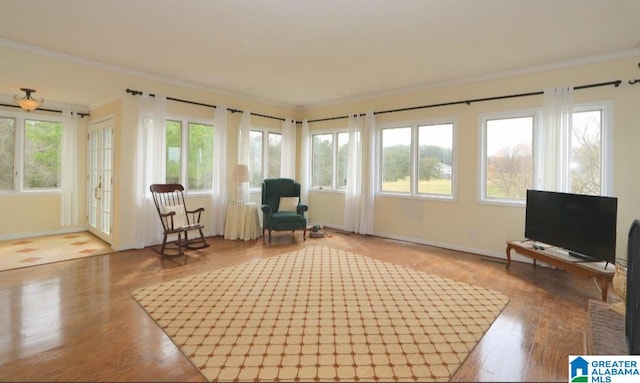 sitting room featuring ornamental molding and light hardwood / wood-style floors