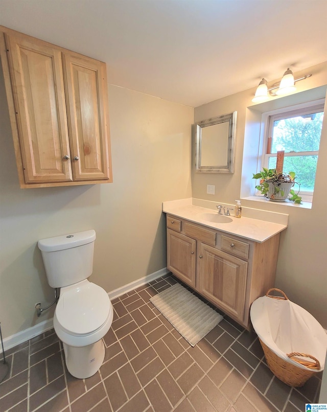 bathroom featuring vanity, tile patterned flooring, and toilet