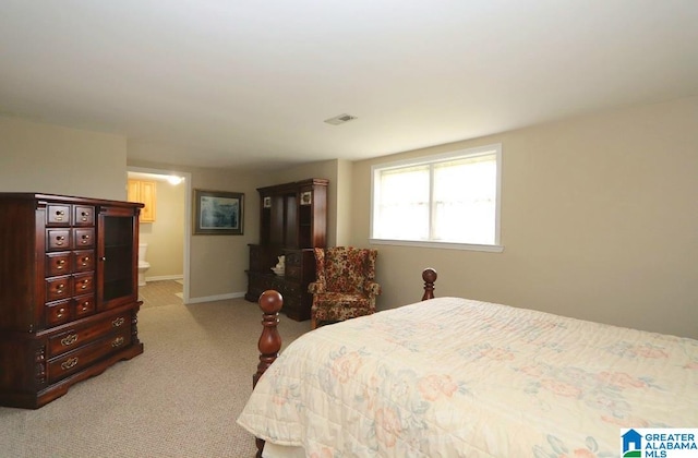 carpeted bedroom featuring ensuite bathroom