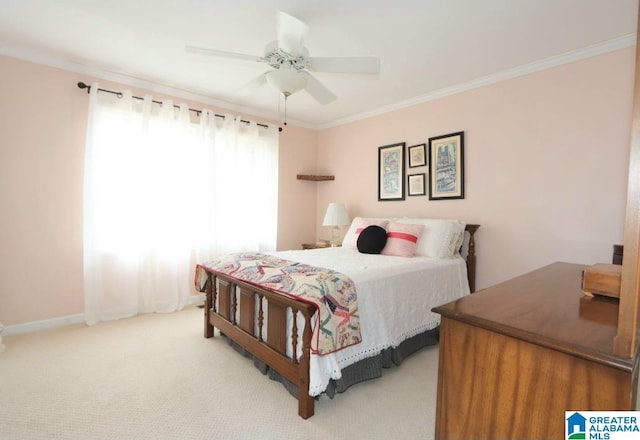 carpeted bedroom with ornamental molding and ceiling fan