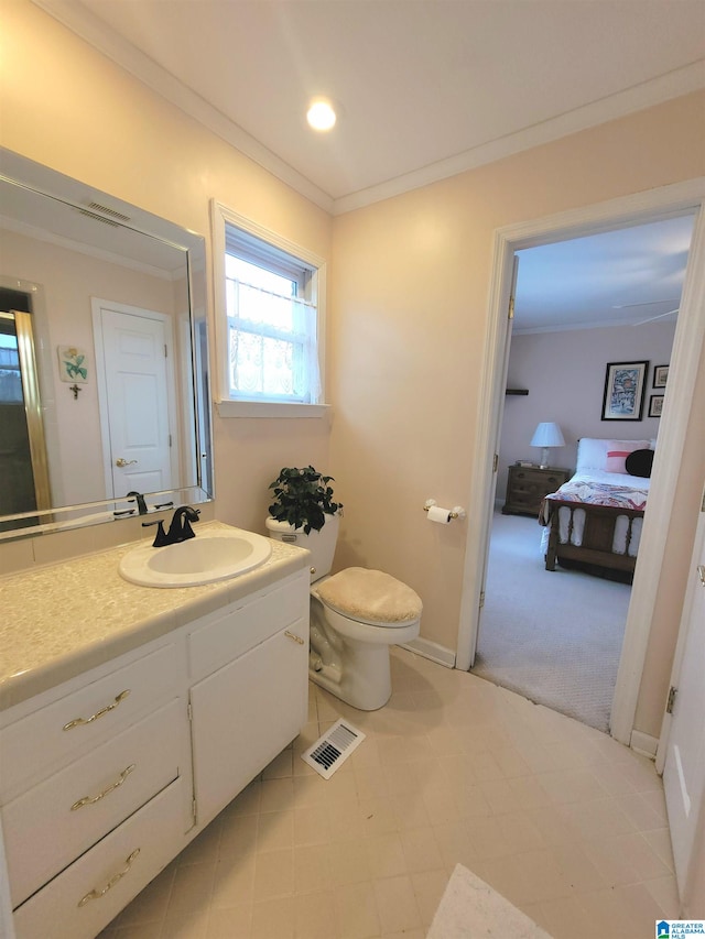 bathroom with vanity, ornamental molding, tile patterned flooring, and toilet