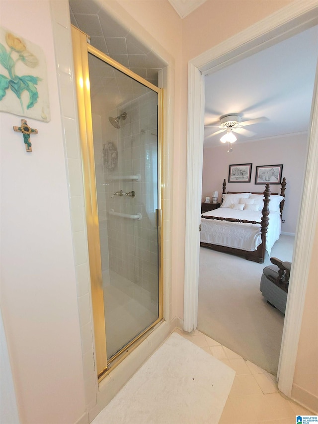 bathroom with tile patterned floors, a shower with door, and ceiling fan