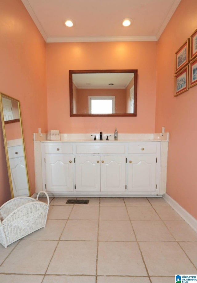 bathroom featuring ornamental molding, vanity, and tile patterned flooring