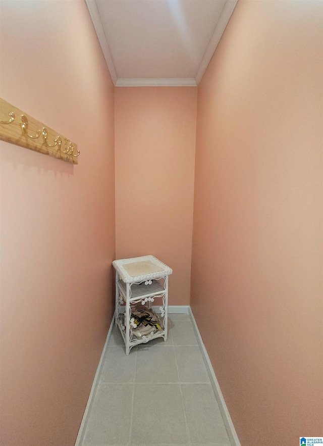 corridor featuring light tile patterned floors and ornamental molding