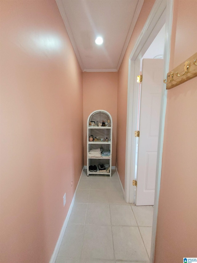 hall featuring crown molding and light tile patterned floors