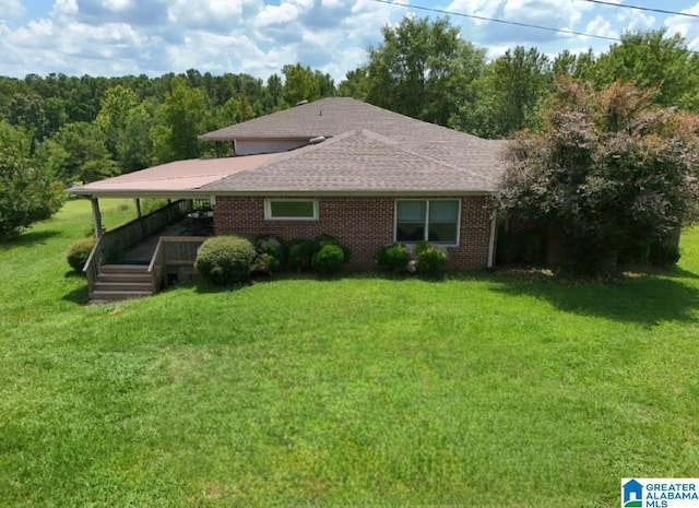 view of front facade with a deck and a front lawn