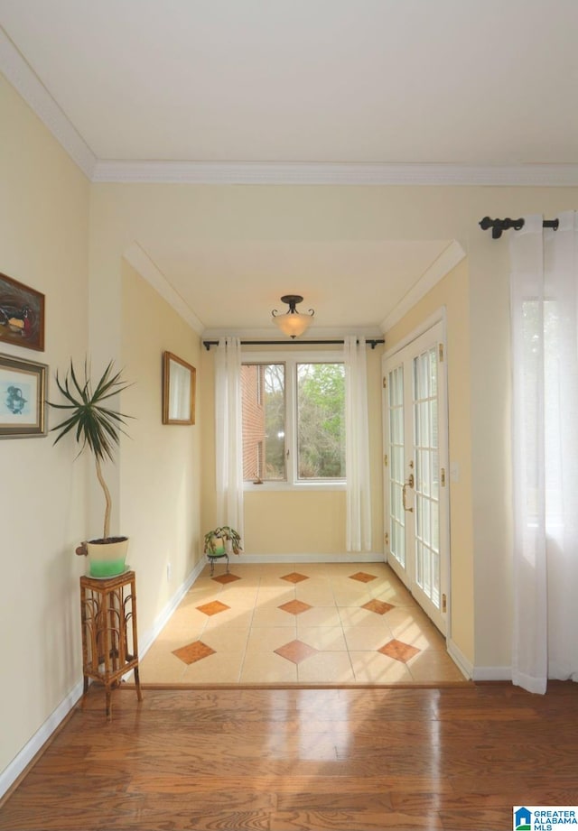 entryway featuring hardwood / wood-style flooring, crown molding, and french doors