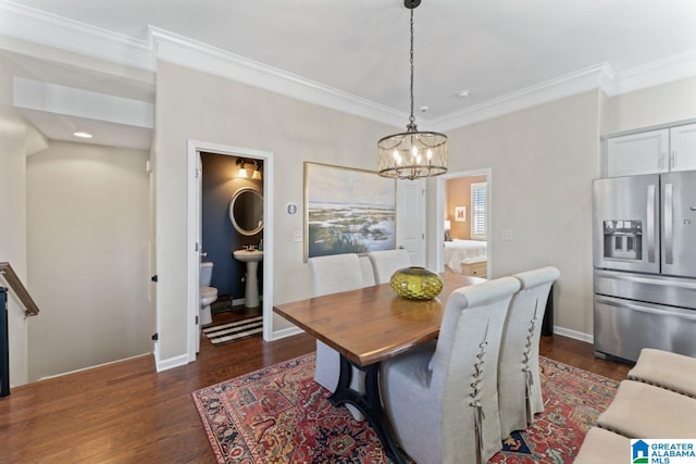 dining room featuring a chandelier, dark hardwood / wood-style floors, and crown molding