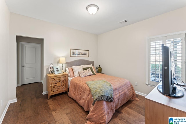 bedroom with dark wood-type flooring