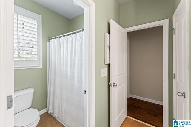 bathroom with toilet and hardwood / wood-style floors