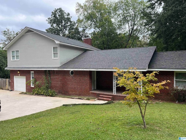 split level home with a front yard and a garage