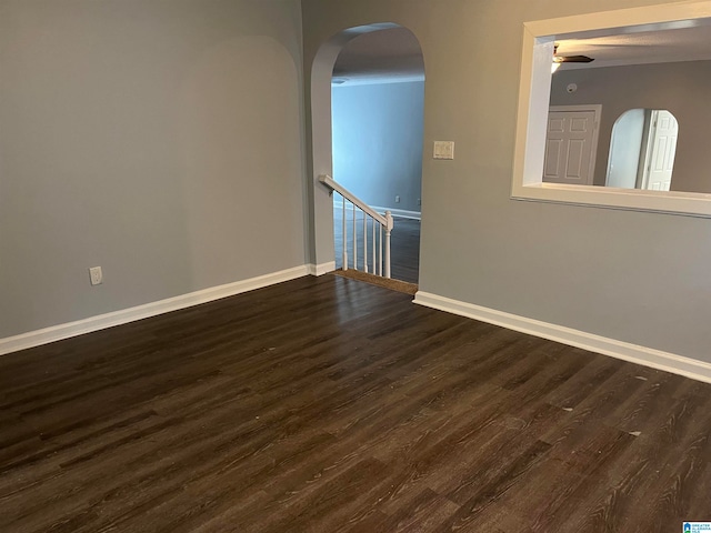 unfurnished room with dark hardwood / wood-style floors and ceiling fan