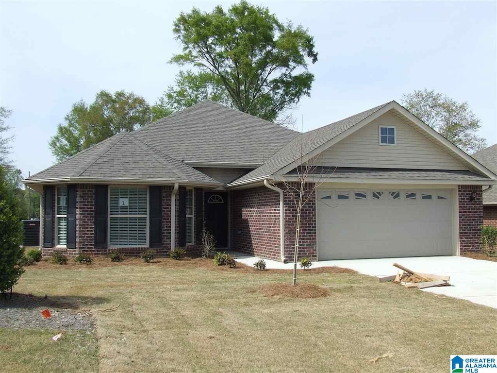 ranch-style home with a front yard and a garage