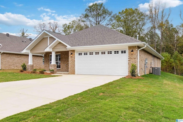 view of front of property with a front yard, central AC, and a garage