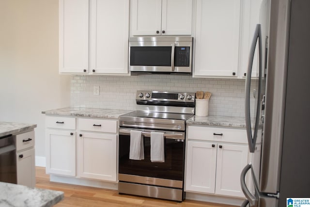 kitchen featuring white cabinetry, appliances with stainless steel finishes, and light hardwood / wood-style flooring