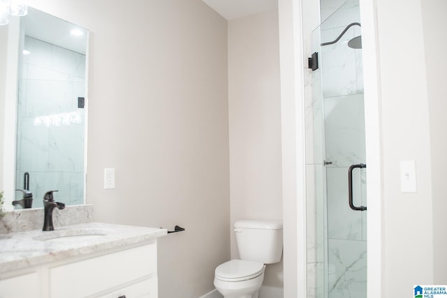 bathroom featuring an enclosed shower, vanity, and toilet