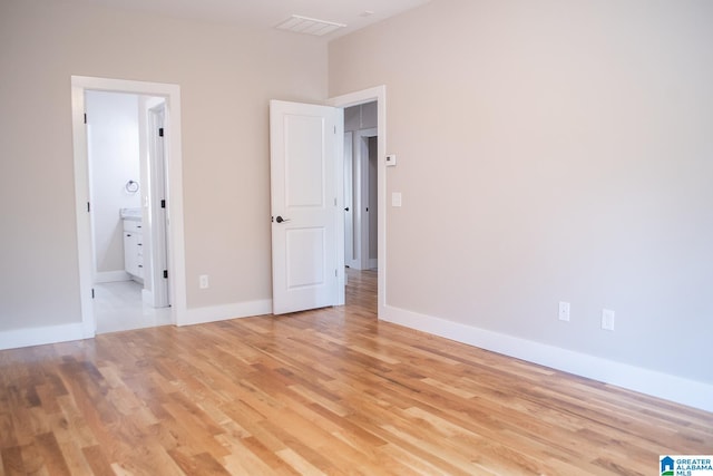 spare room featuring light hardwood / wood-style floors