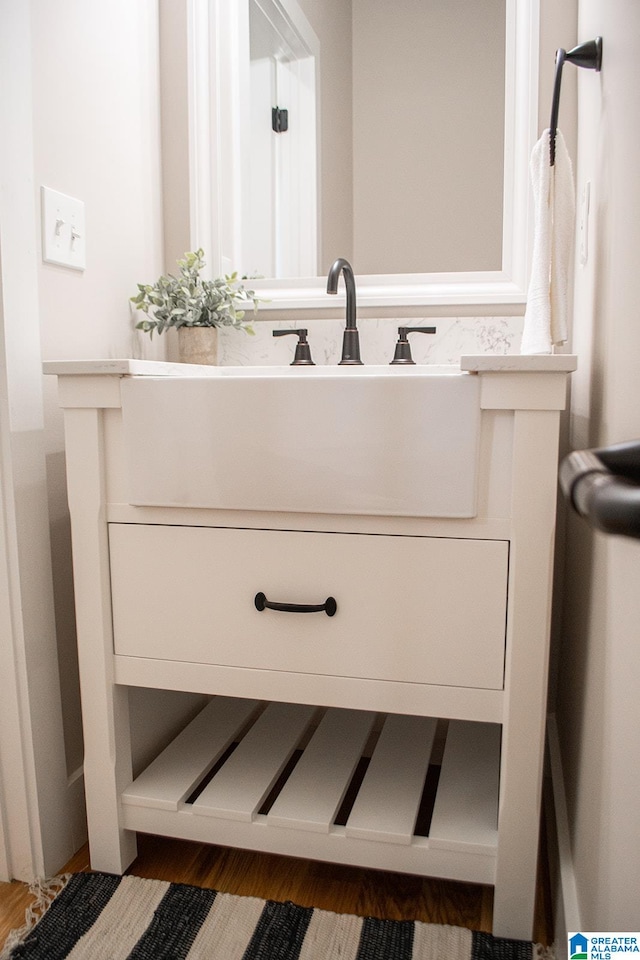 bathroom with vanity and hardwood / wood-style floors