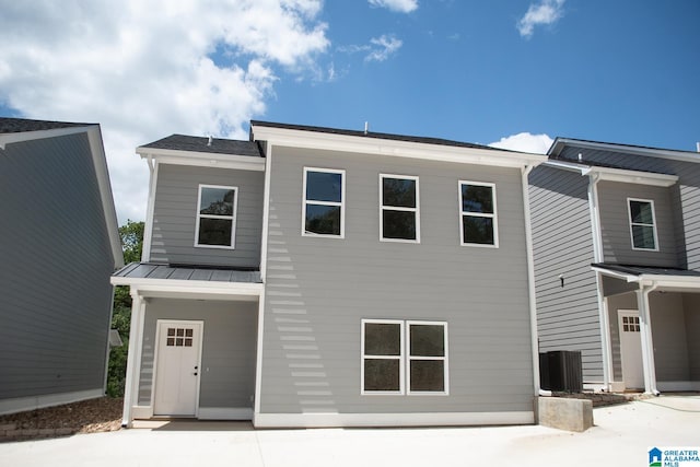 view of front of home with central air condition unit and a patio