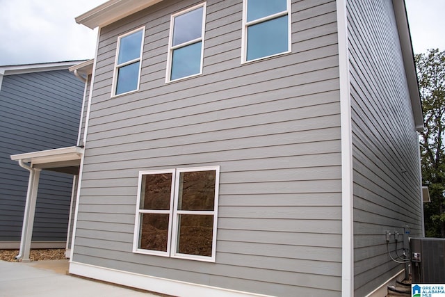 view of side of property featuring central air condition unit