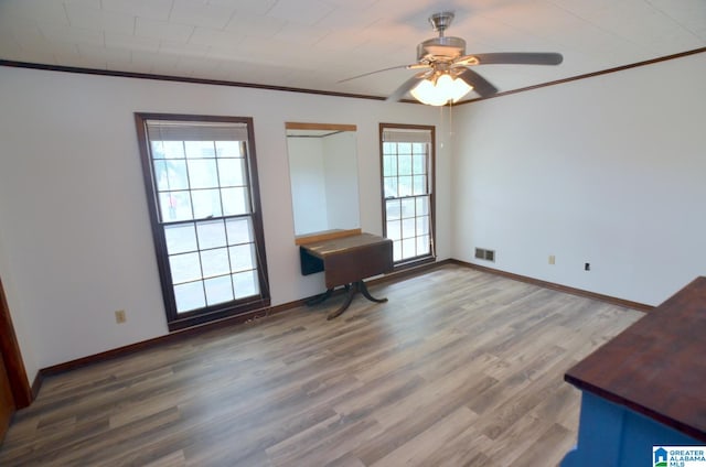 unfurnished room featuring ornamental molding, ceiling fan, and hardwood / wood-style flooring