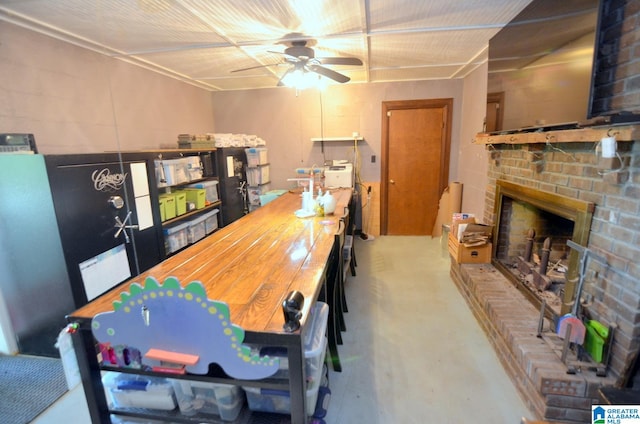 dining space featuring ceiling fan and a brick fireplace