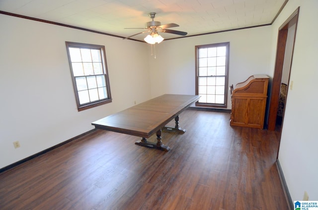 unfurnished office with a healthy amount of sunlight, dark hardwood / wood-style floors, ceiling fan, and crown molding