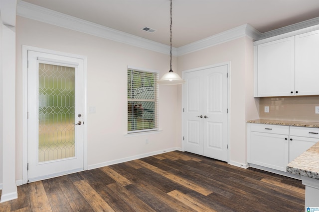 kitchen with white cabinets, dark hardwood / wood-style flooring, and ornamental molding