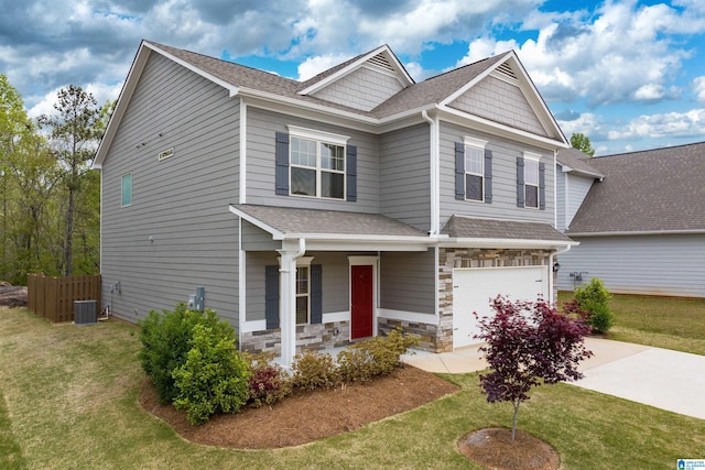 craftsman house with central AC, a front lawn, and a garage