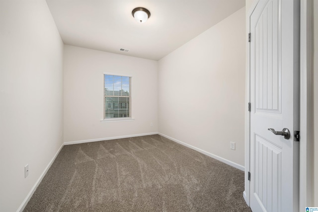 unfurnished room with dark carpet