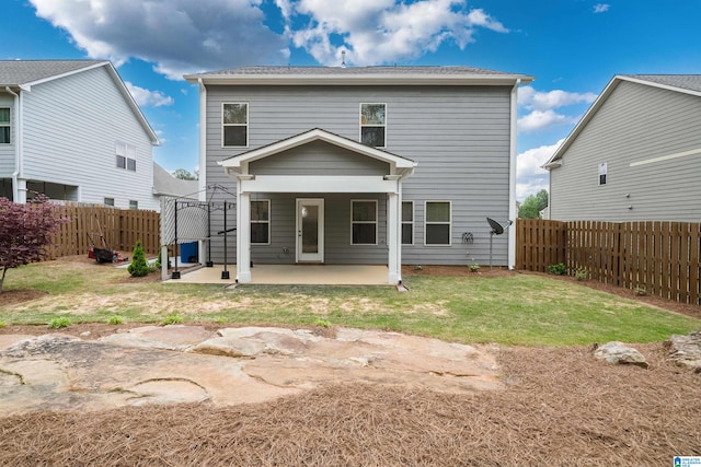 back of property featuring a patio and a yard