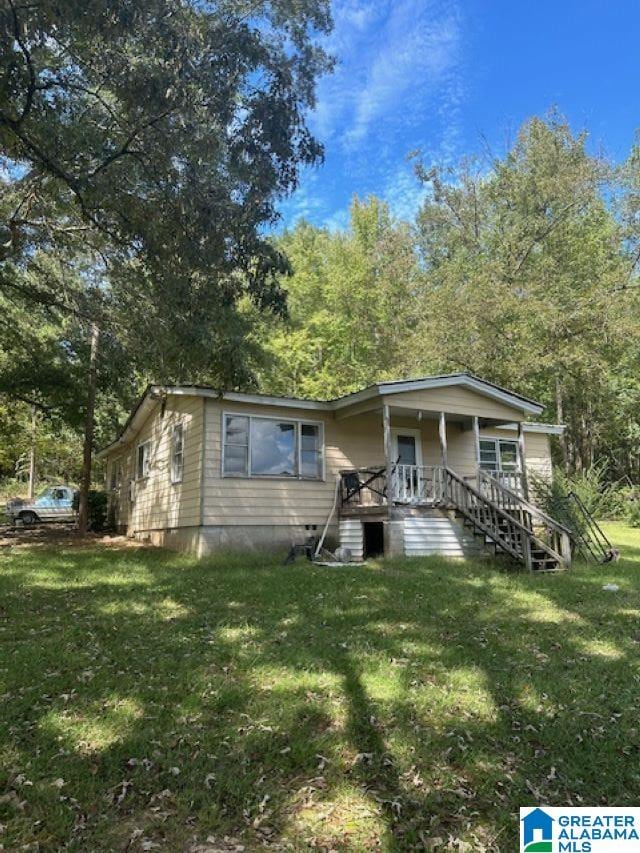 bungalow-style house featuring a porch and a front lawn