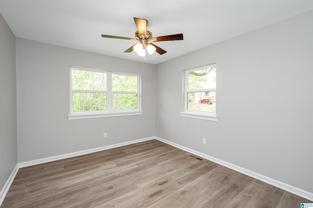 empty room featuring ceiling fan and light wood-type flooring