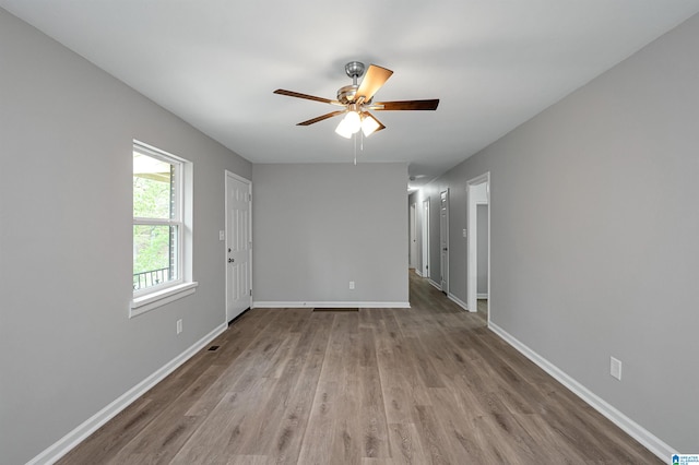 spare room featuring ceiling fan and hardwood / wood-style flooring