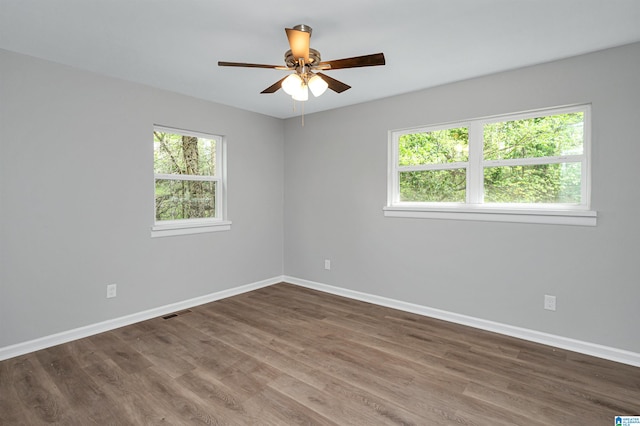 spare room featuring ceiling fan and dark hardwood / wood-style floors