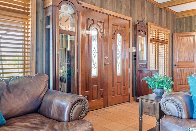 entryway with wood walls and light tile flooring