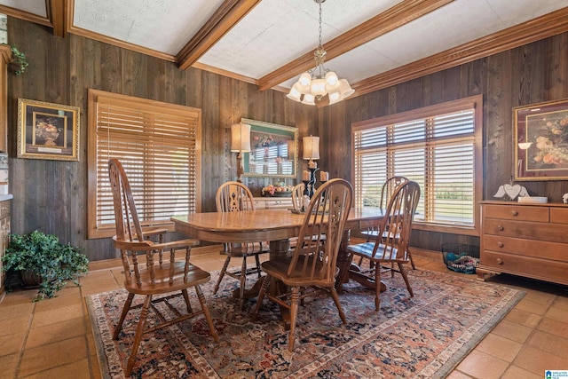 dining room with light tile floors, wooden walls, an inviting chandelier, and beamed ceiling