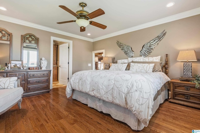 bedroom with dark hardwood / wood-style floors, ornamental molding, and ceiling fan