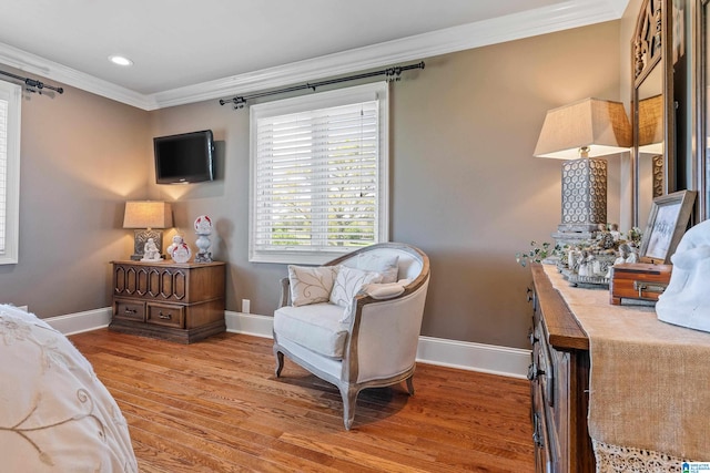 bedroom featuring ornamental molding and light hardwood / wood-style floors